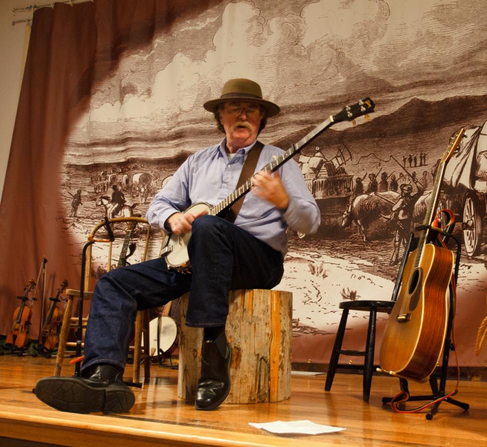P1010921.jpg - A volunteer musical docent offers period tunes and tales of the trail.