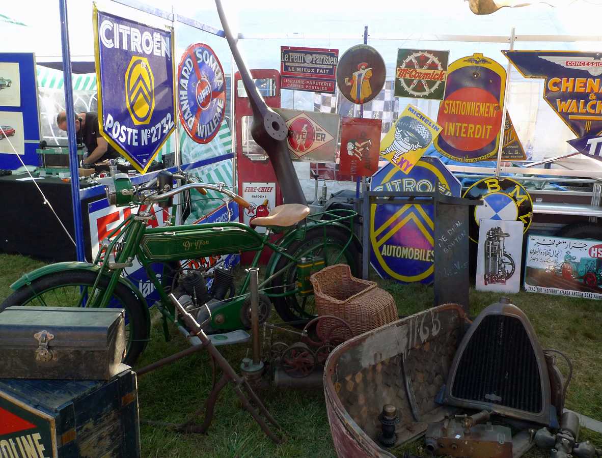 L1010188.JPG - This fellow had quite a range of goods; tin signs, parts, props, and an old flat tank Griffon.