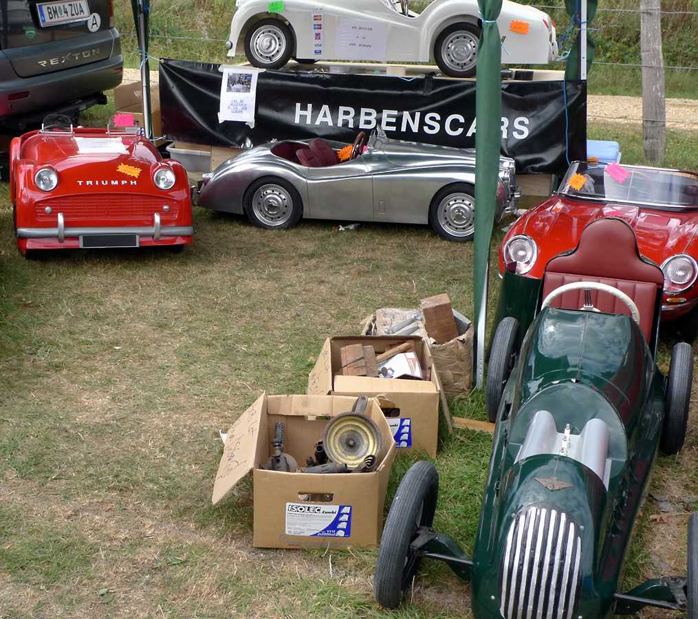 L1010232.JPG - A line of classic pedal cars and musical (really) cars.