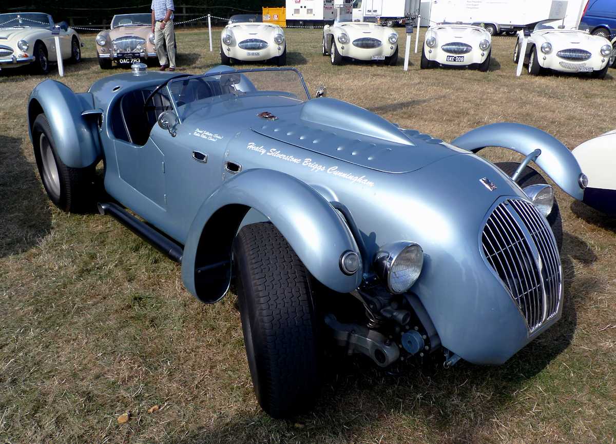 L1010723.JPG - In the Healey club parking area a Healey Siverstone fronts four, count 'em four, very rare and desirable Austin Healey 100S models.