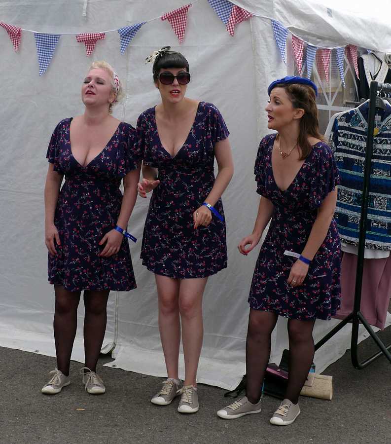 L1010955.JPG - Never mind the athletic shoes, it's a long day singing to the crowd and the puppies need tending.