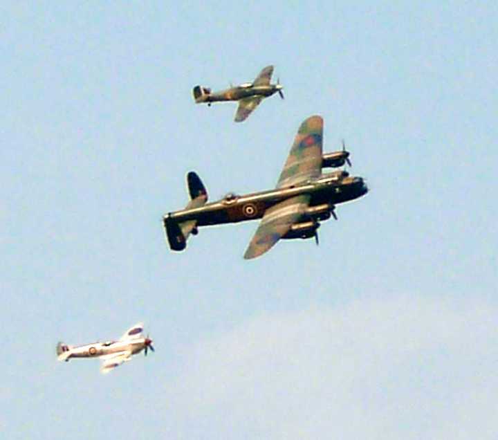 L1010674.JPG - There were several flyovers each day, this Lancaster thundered along with its Spitfire escorts.