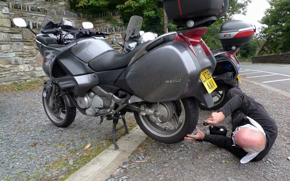 L1010464.JPG - Our final Welsh adventure. I picked up a nail in the rear tire. Neil repaired it with the tire kit we carried.